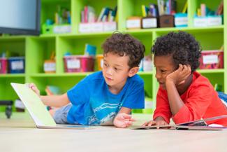 Two boys looking at a book